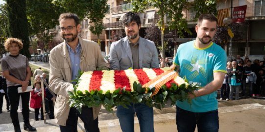 Ofrena floral de l'Ajuntament al peu de la senyera de la pl. de Catalunya.